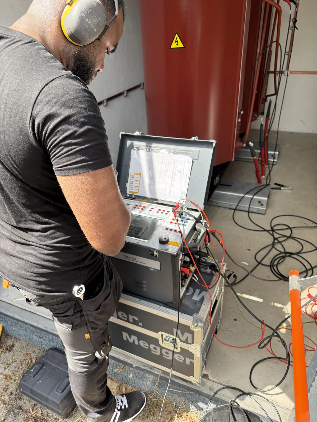 Technician performing an electrical transformer test