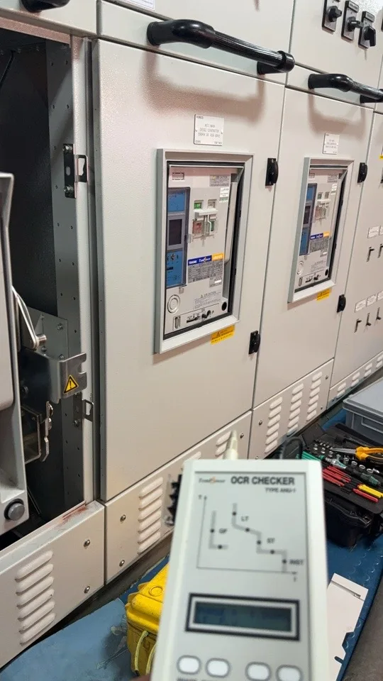Low-voltage circuit breakers in an electrical switchboard during inspection